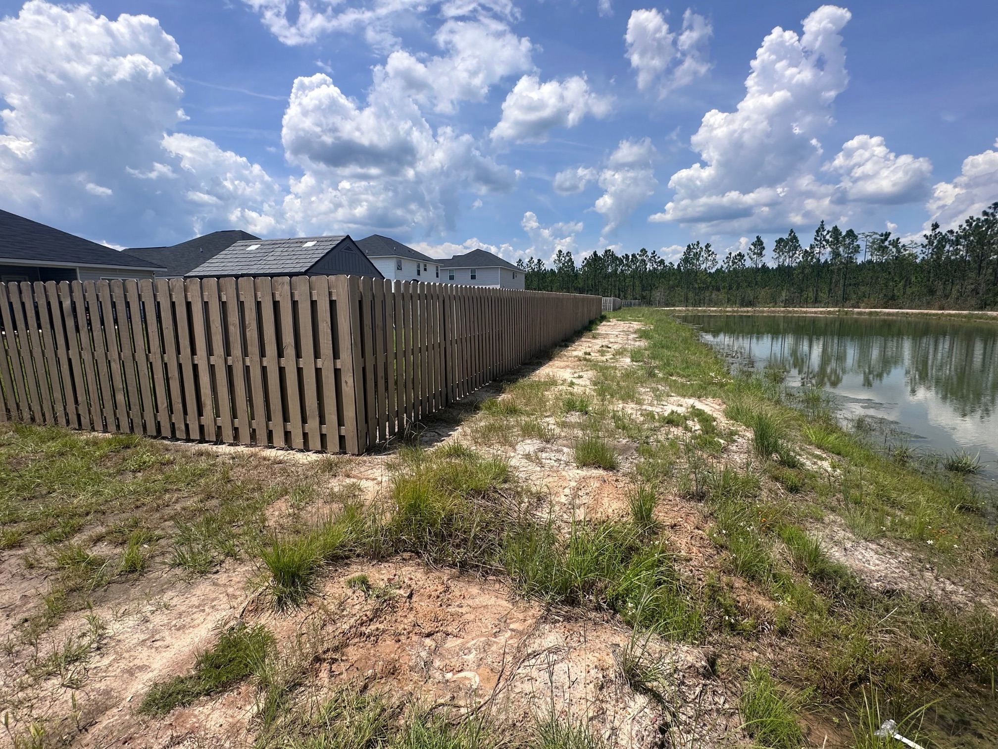Walthour Legacy Enterprises privacy fence project beside a pond, Hinesville GA